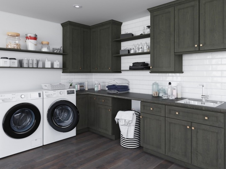 Discover a stylish and functional laundry room featuring dark green cabinets, white appliances, and ample storage for efficient laundry days.